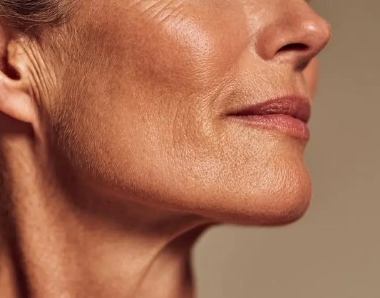 Close-up of a mature woman's jawline and neck area showing natural skin texture, relevant to skin firming and tightening treatments